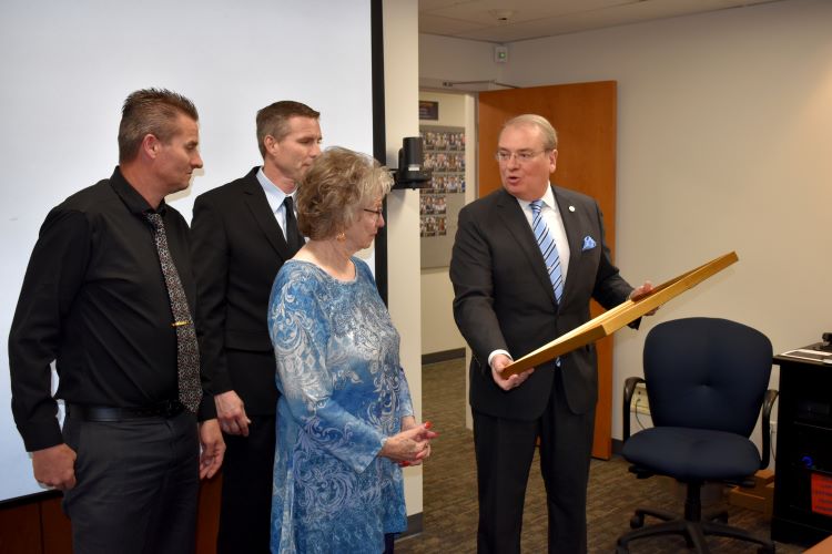 Image of Doctor Robert C. Nelson's wife receiving the Victor J. Stello Junior Award for Safety Leadership on behalf of her husband.