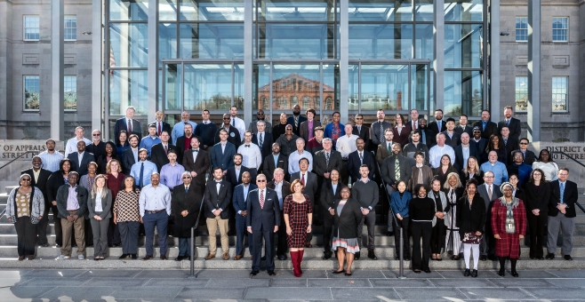 Group image of DNFSB employees and contractors standing on steps in front of a building