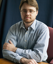 Image of Ben Caleca sitting at a table