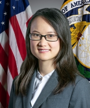 Image of Leigh Lin in front of the American flag